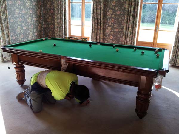 Billiard table removalists reassembling a 9 foot pool table