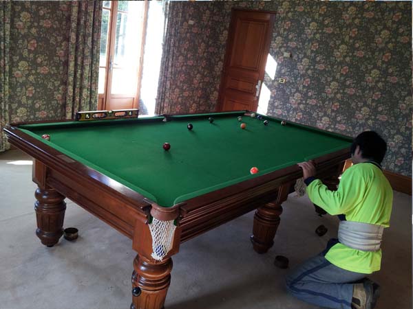 Billiard table removalists reassembling a 10 foot pool table