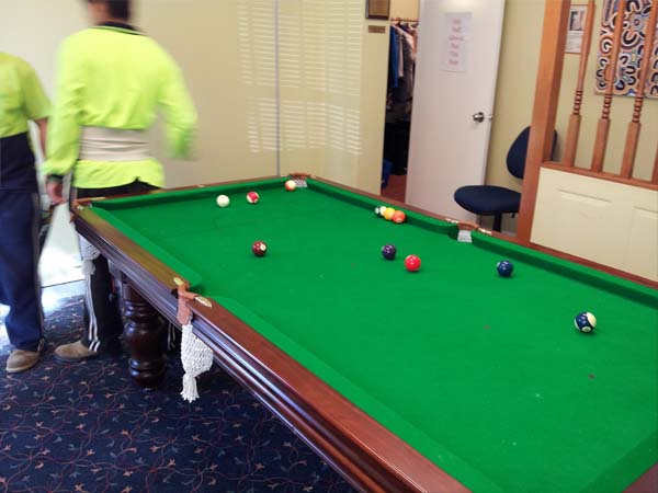 Billiard table removalists reassembling large pool table